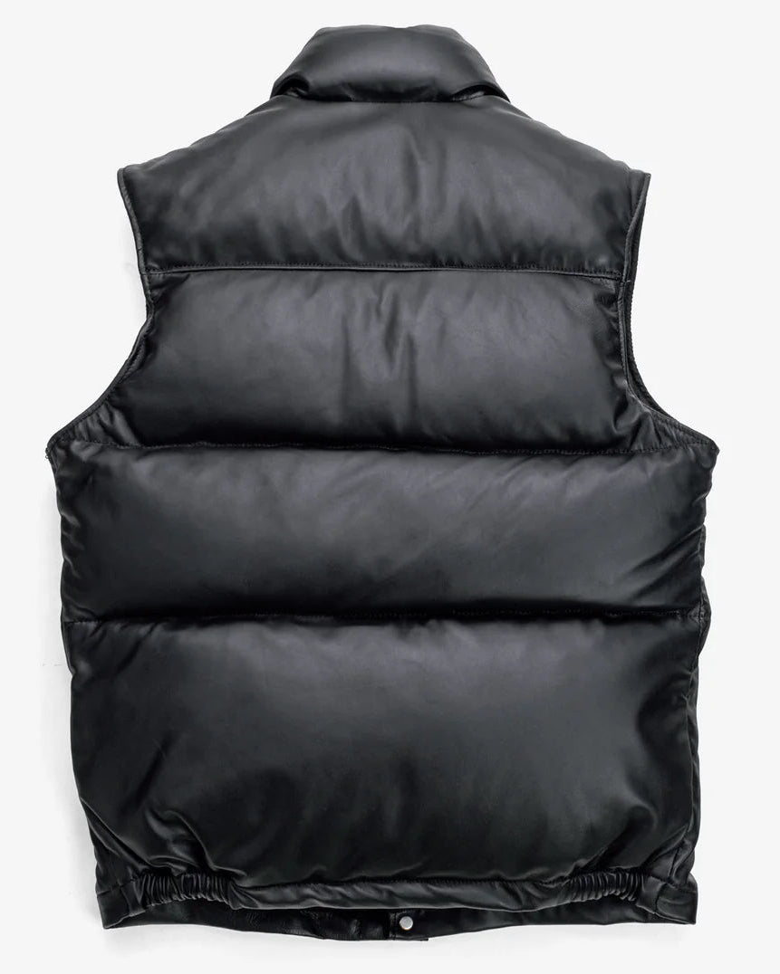 back showcase of the Leveljacket Matte Black leather quilted puffer vest, detailing its wide horizontal thermal baffles, high insulated stand-up collar, front vertical zipper pockets, snap-button closure placket, and elasticated lower back hem.