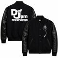 Front and back catalog layout of the Leveljacket Def Jam Recordings black varsity jacket, displaying a premium black wool body with black leather sleeves, custom white embroidered turntable needle art on the front chest, and a bold white Def Jam Recordings typography patch layout across the back.
