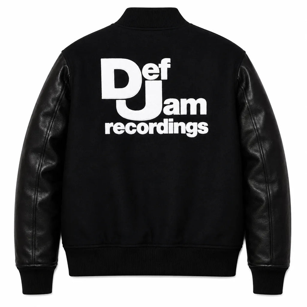 Front and back catalog layout of the Leveljacket Def Jam Recordings black varsity jacket, displaying a premium black wool body with black leather sleeves, custom white embroidered turntable needle art on the front chest, and a bold white Def Jam Recordings typography patch layout across the back.