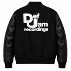 Front and back catalog layout of the Leveljacket Def Jam Recordings black varsity jacket, displaying a premium black wool body with black leather sleeves, custom white embroidered turntable needle art on the front chest, and a bold white Def Jam Recordings typography patch layout across the back.