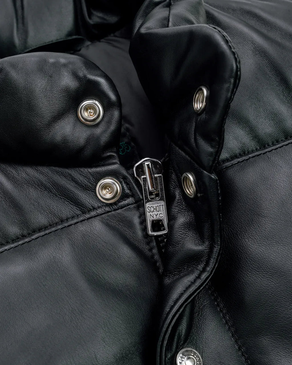 Collar zoom showcase of the Leveljacket Matte Black leather quilted puffer vest, detailing its wide horizontal thermal baffles, high insulated stand-up collar, front vertical zipper pockets, snap-button closure placket, and elasticated lower back hem.