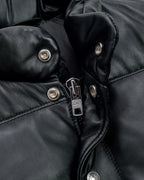 Collar zoom showcase of the Leveljacket Matte Black leather quilted puffer vest, detailing its wide horizontal thermal baffles, high insulated stand-up collar, front vertical zipper pockets, snap-button closure placket, and elasticated lower back hem.